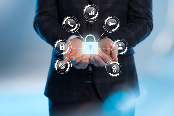 partial view of businessman with outstretched hands and internet security icons above on blue background