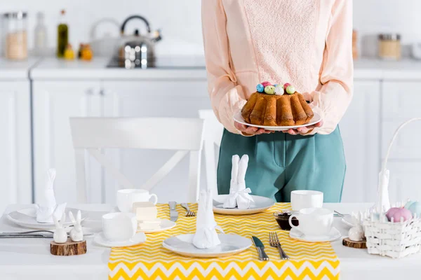 Cropped View Woman Holding Plate Easter Bread While Setting Table — Stock Photo, Image