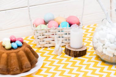 Boyalı yumurta, mum ve masada seramik bunny Paskalya kek