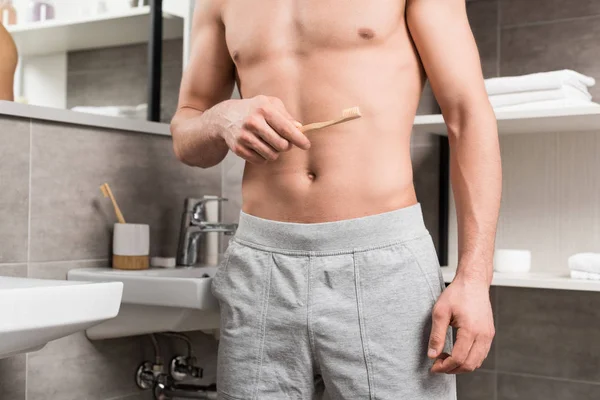 Cropped View Man Holding Toothbrush While Standing Bathroom — Stock Photo, Image