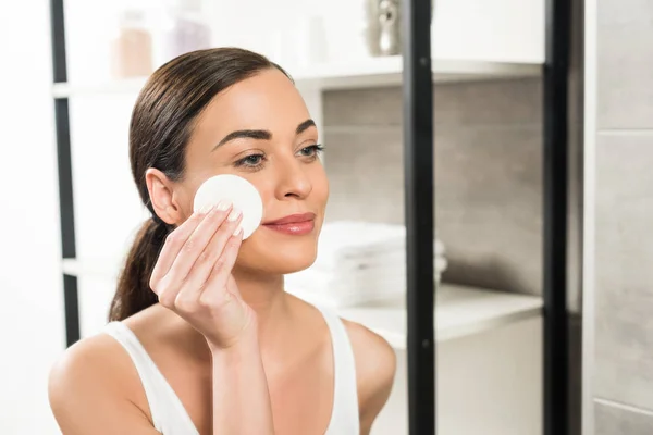 Attractive Brunette Woman Holding Cotton Pad Face While Looking Mirror — Stock Photo, Image