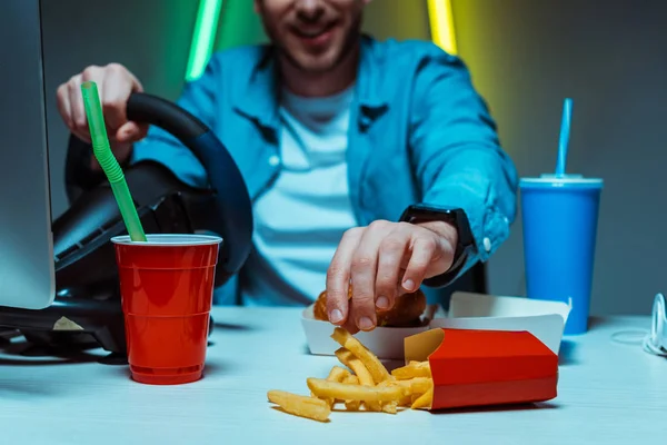Selective Focus Cyber Sportsman Eating French Fries Holding Steering Wheel — Stock Photo, Image