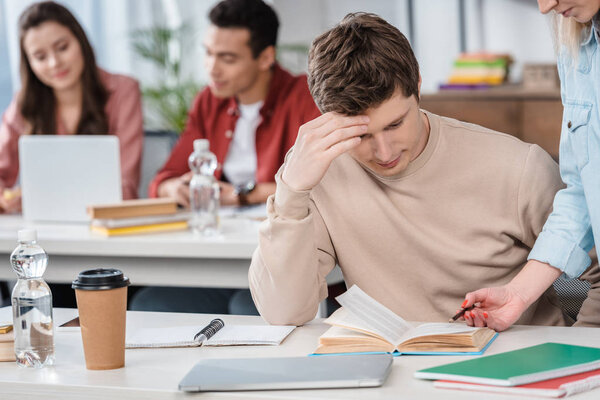 Partial view of woman with pencil explaining lesson to student