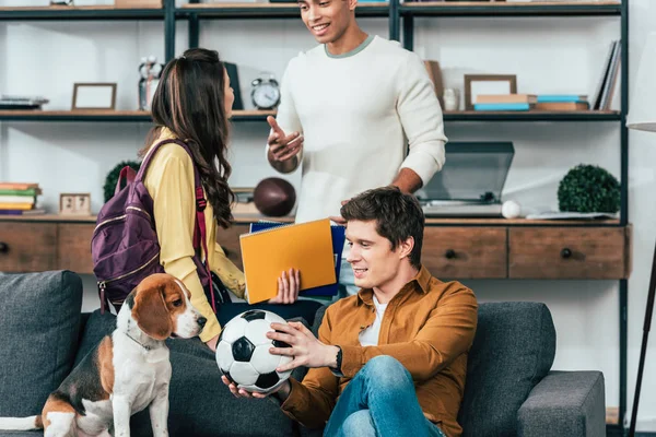 Multiethnic Students Notebooks Football Ball Sitting Sofa Dog — Stock Photo, Image