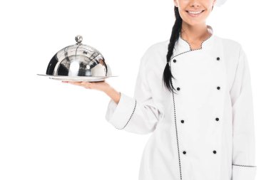 Cropped view of chef in uniform holding tray with cloche isolated on white clipart