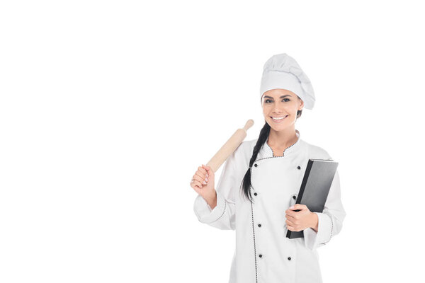 Chef in hat holding rolling pin and book isolated on white