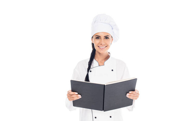 Chef in uniform holding black book isolated on white