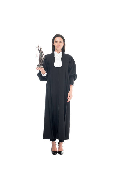 Full length view of judge in judicial robe holding themis figurine isolated on white