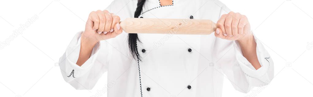 Panoramic shot of chef in uniform holding rolling pin isolated on white