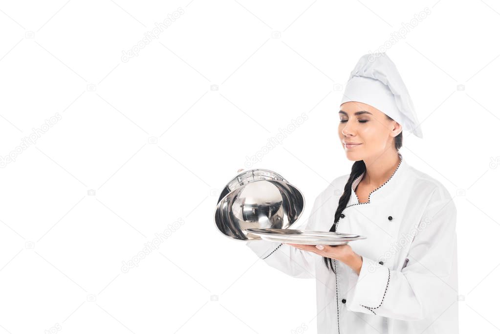 Chef in hat holding tray with cloche isolated on white