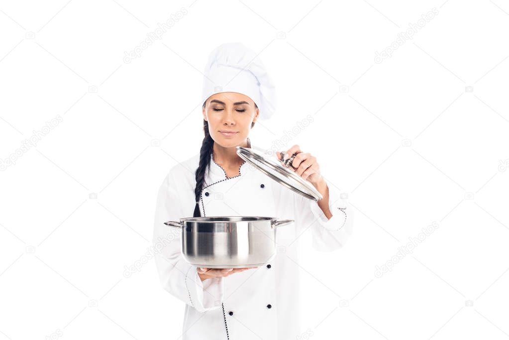 Chef in uniform holding steel pot with closed eyes isolated on white