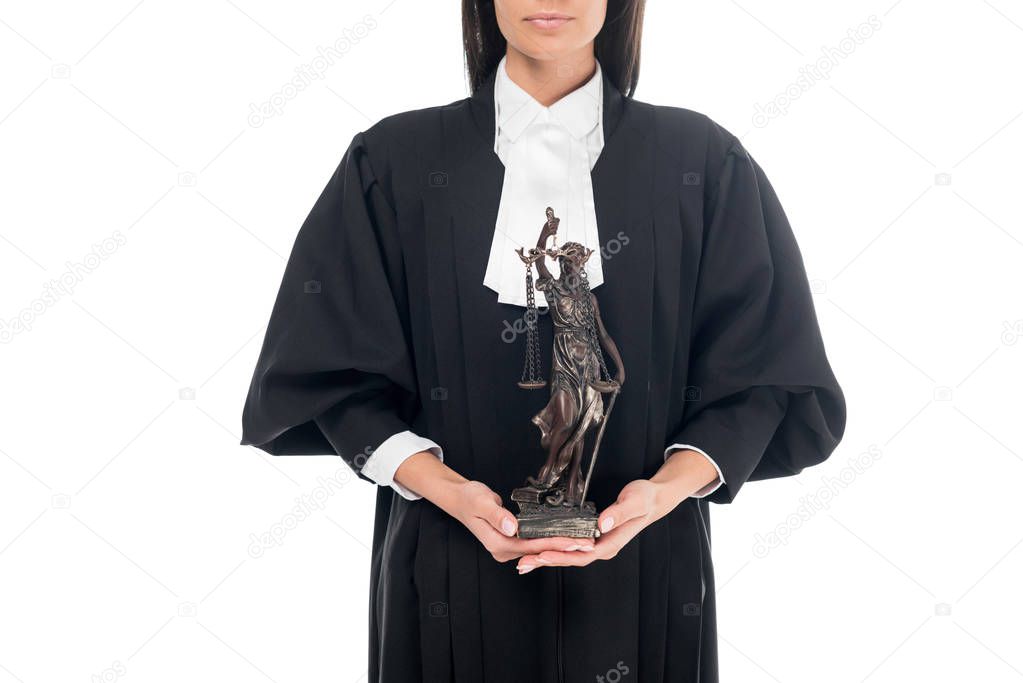 Partial view of judge in judicial robe holding themis figurine isolated on white