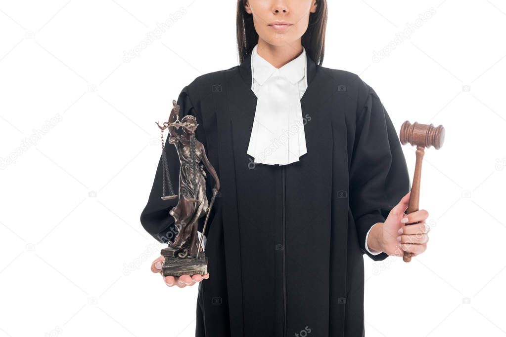 Partial view of judge in judicial robe holding gavel and themis figurine isolated on white