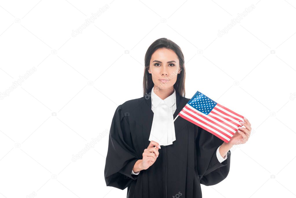 Judge in judicial robe holding american flag isolated on white