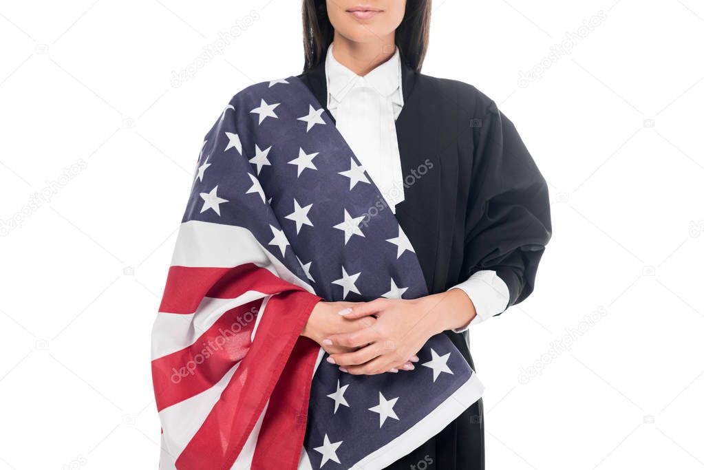 Cropped view of judge in judicial robe holding american flag isolated on white