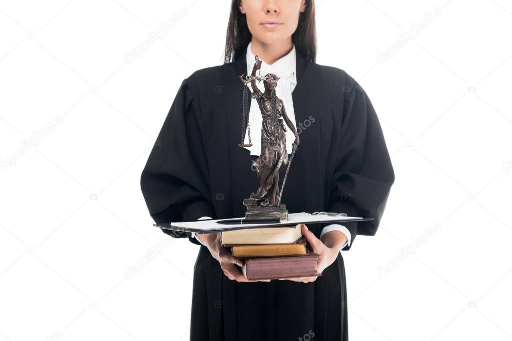 Cropped view of judge in judicial robe holding themis figurine, books and clipboard isolated on white