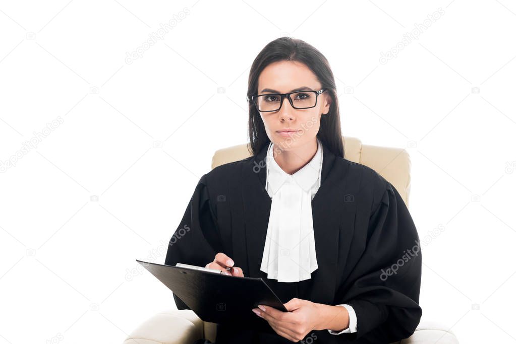 Judge sitting in armchair and holding clipboard isolated on white