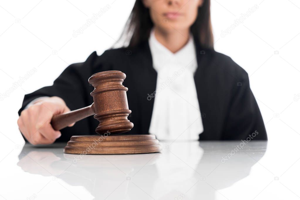 Partial view of judge in judicial robe holding gavel isolated on white
