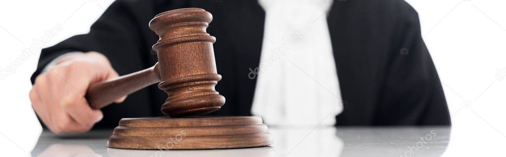 Panoramic shot of judge in judicial robe holding gavel isolated on white