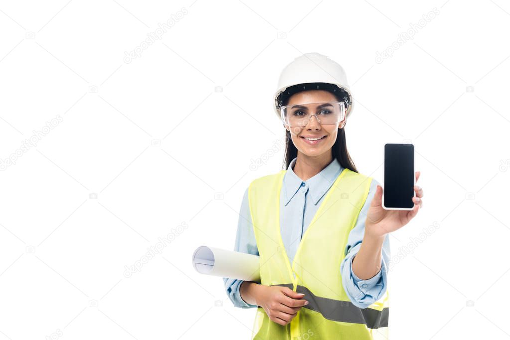 Smiling engineer with blueprint showing smartphone with blank screen isolated on white