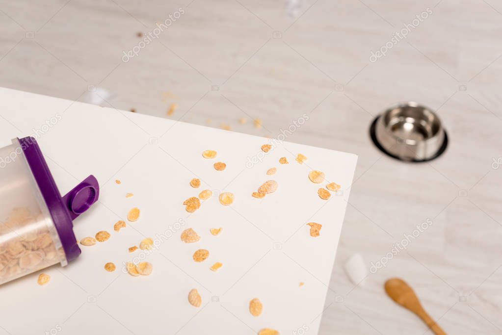 selective focus of cereals on white surface in messy kitchen 
