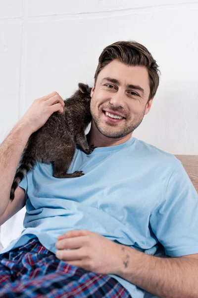 Cheerful Handsome Man Cuddling Cute Raccoon Looking Camera — Stock Photo, Image