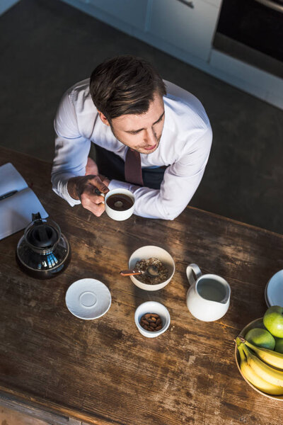 Вид на красивого человека, завтракающего на кухне дома
