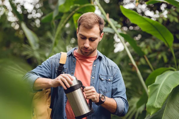 Selective Focus Traveler Backpack Opening Thermos Tropical Forest — Stock Photo, Image