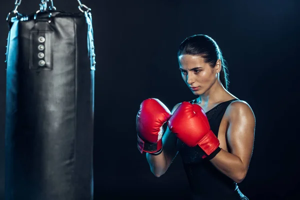 Confident Boxer Red Gloves Looking Punching Bag Black — Stock Photo, Image