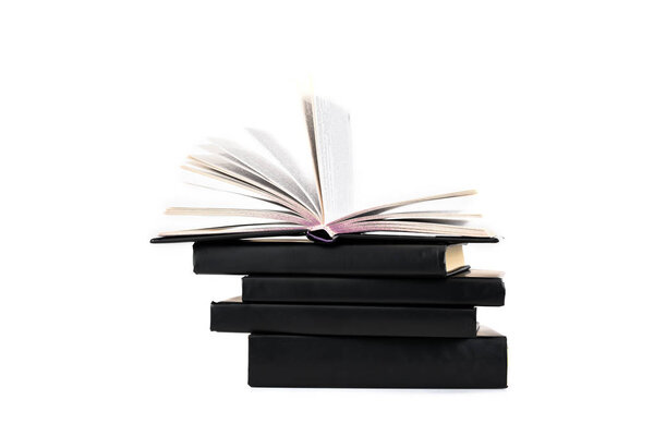 Stack of black hardcover books isolated on white