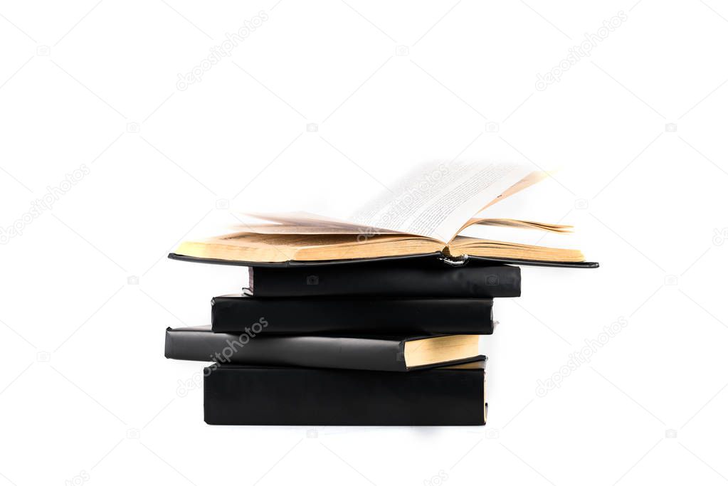 Stack of black hardcover books isolated on white