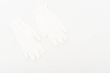 Two white rubber gloves isolated on white surface clipart