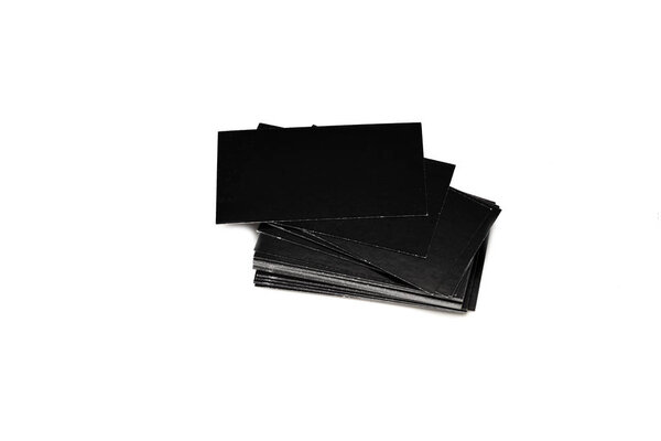Stack of empty black business cards on white