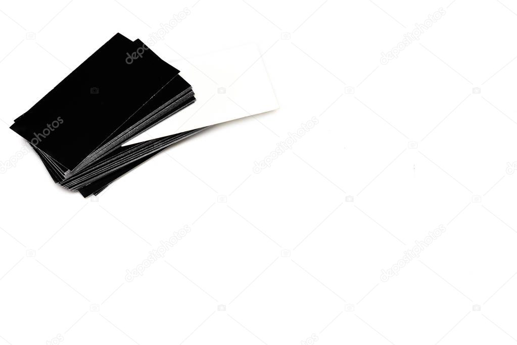 Stack of empty black and white business cards on white