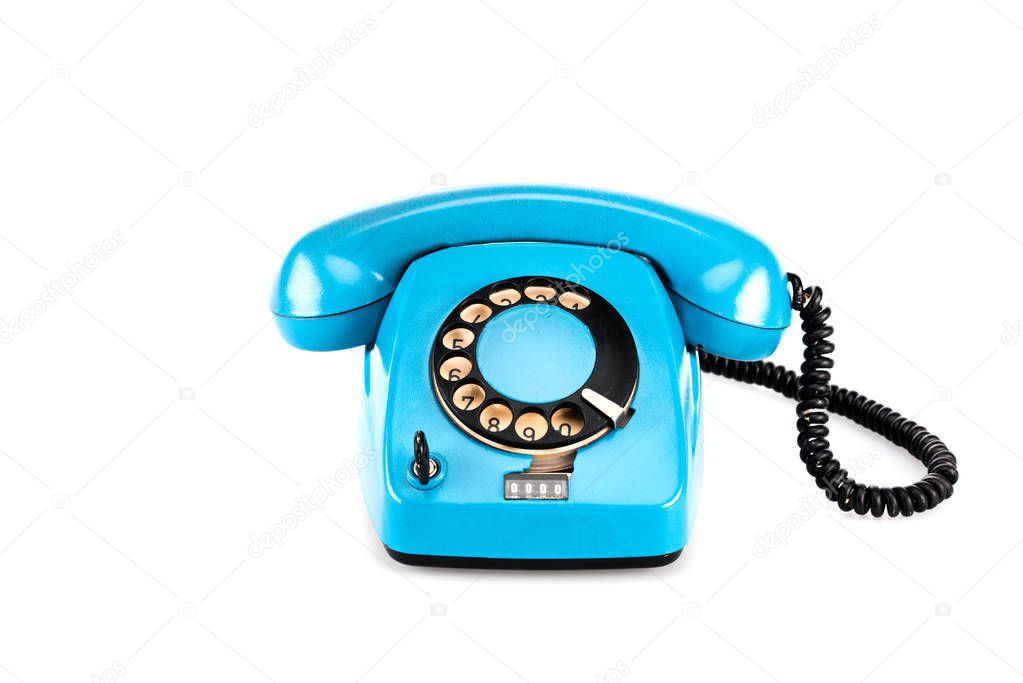Blue vintage telephone with handset and wire on white