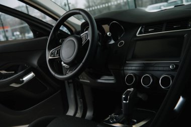 black steering wheel near manual transmission in luxury car  clipart
