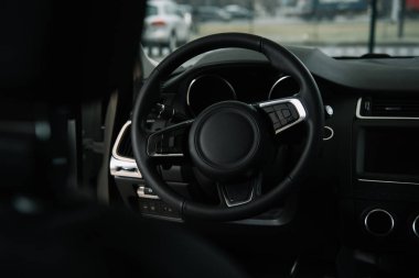 selective focus of steering wheel in luxury car  clipart