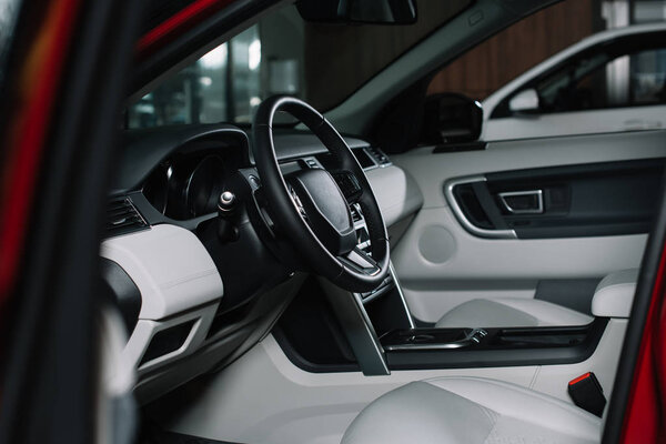 selective focus of black steering wheel in automobile 