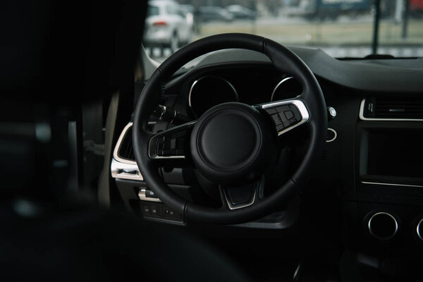 selective focus of steering wheel in luxury car 
