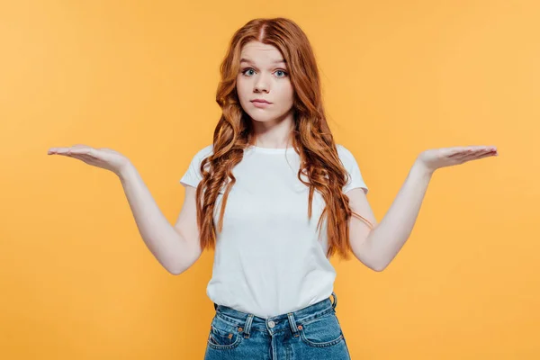 Beautiful Redhead Girl Looking Camera Showing Shrug Gesture Isolated Yellow — Stock Photo, Image