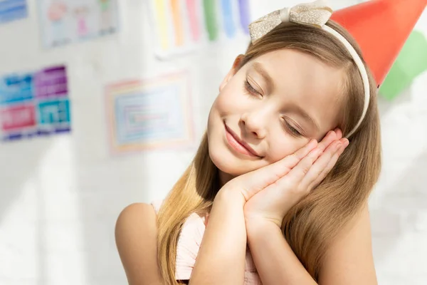 Adorable Smiling Kid Party Cap Eyes Closed Leaning Head Hands — Stock Photo, Image