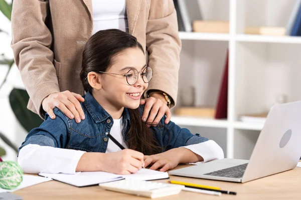 Cropped View Mother Putting Hands Shoulders Happy Kid Looking Laptop — Stock Photo, Image