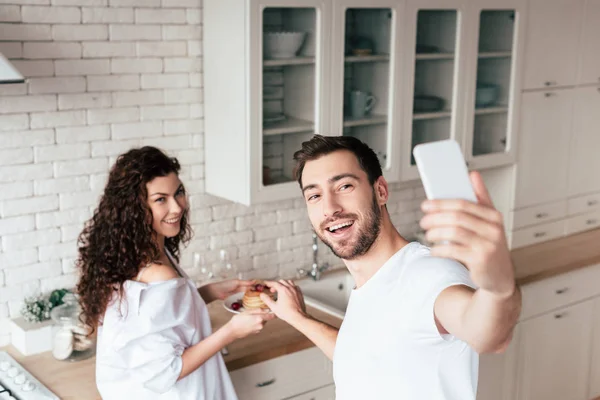 Sorrindo Casal Tomando Selfie Com Capcakes Cozinha — Fotografia de Stock