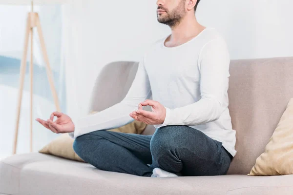 Cropped View Man Eyes Closed Sitting Couch Lotus Pose Meditating — Stock Photo, Image