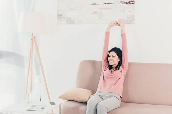 Beautiful Smiling Woman Sitting Couch Stretching Home — Stock Photo, Image