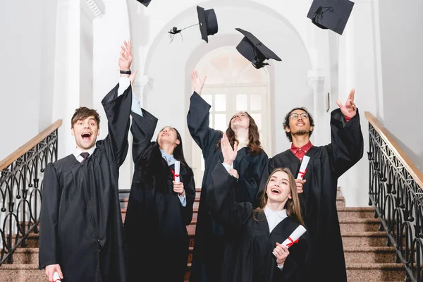 Happy Students Smiling While Throwing Air Graduation Caps — Stock Photo, Image