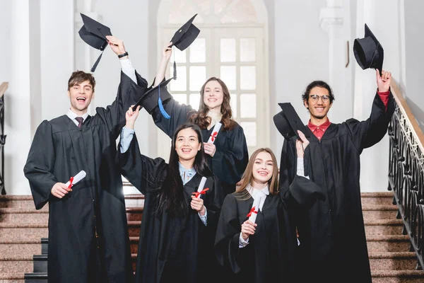 Fröhliche Gruppe Von Studenten Lächelt Während Sie Abschlussmützen Der Hand — Stockfoto