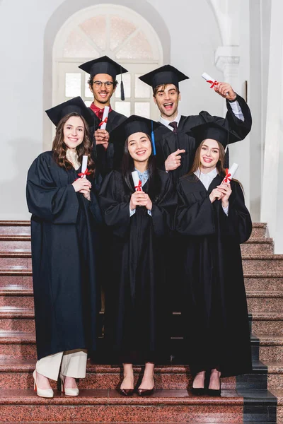 Cheerful Group Students Graduation Gowns Holding Diplomas — Stock Photo, Image