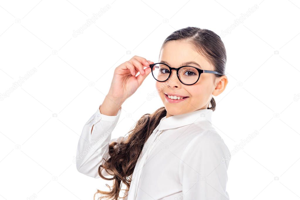 adorable schoolgirl in formal wear and glasses smiling and looking at camera Isolated On White