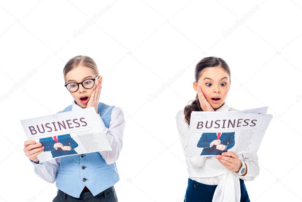 shocked schoolgirls in formal wear reading business newspapers Isolated On White